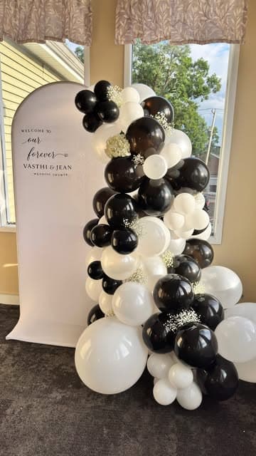 Custom wedding shower backdrop sign with black and white balloon garland