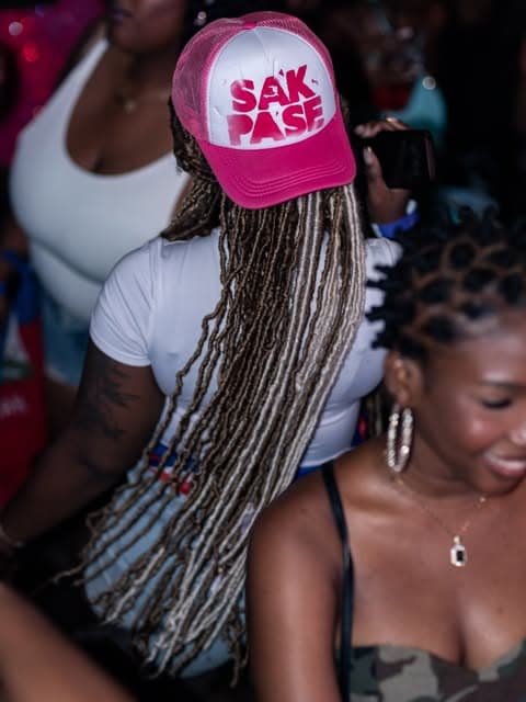 Customer wearing a custom pink trucker hat at an event