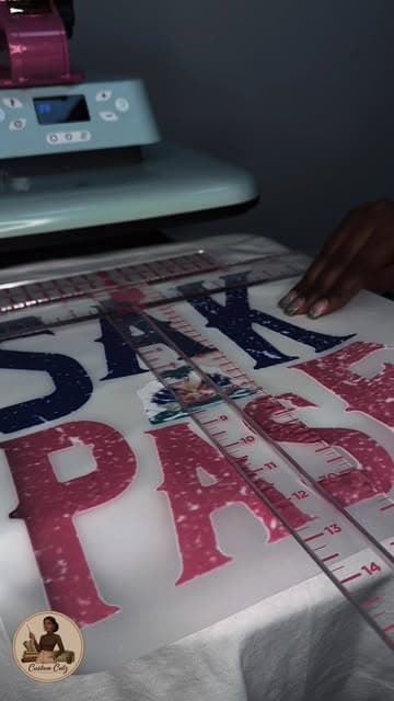 Heat press in progress on a custom 'Sak Pase' design shirt